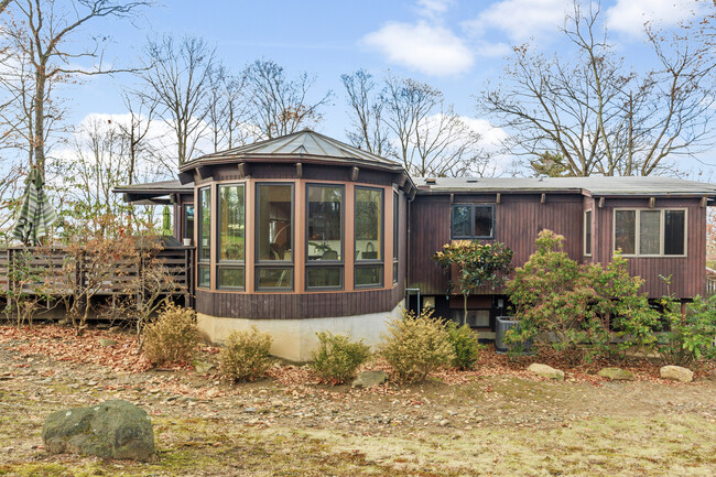 Rear view of the property featuring the yard, deck, and breakfast room. - 19 Cottontail Ln