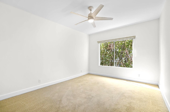 The bedroom is 15 x 12 ft with a blackout shade, and remote ceiling fan. - 2221 Ocean Ave