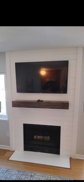 updated fireplace/mounted tv and shelf - 264 Alexandra Dr