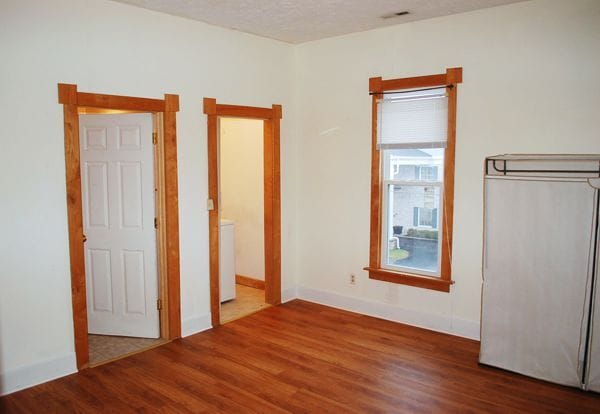 Larger bedroom showing window and doors to bathroom and laundry room. - 1728 I St