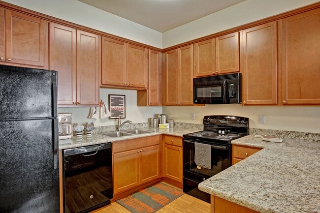 A large kitchen with lots of cabinet sorage, deep double sinks, and plenty of counter space - Riverside 9