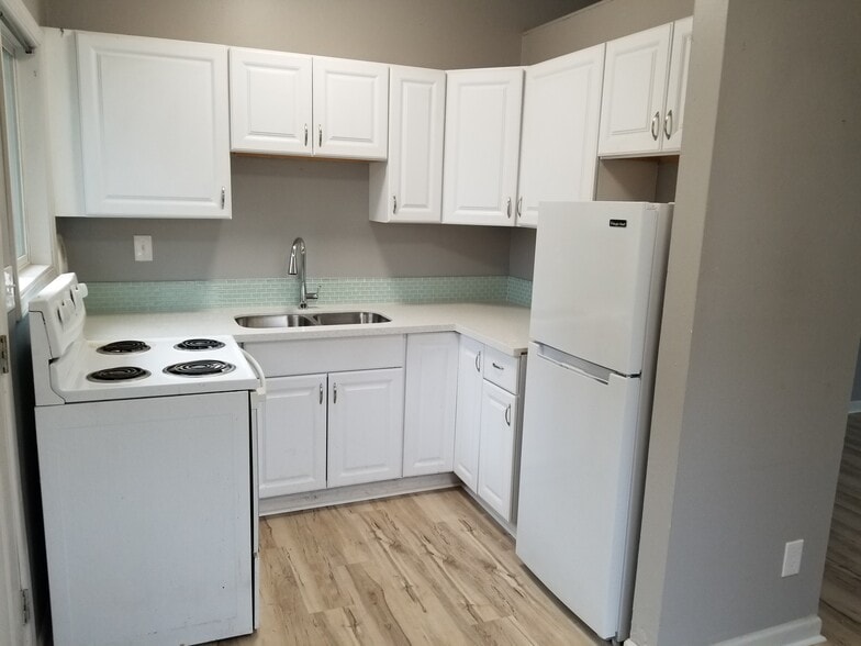 Kitchen with newer cabinets and brand new quartz counters, undermount sink and new faucet. - 5442 -5448 SE Franklin St