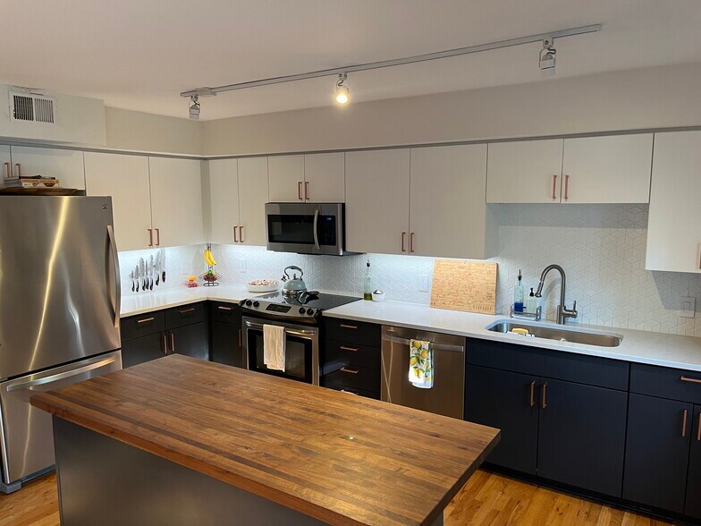 Walnut wood and quartz countertops. Roomy bottom freezer combo. - 1641 N Washington St
