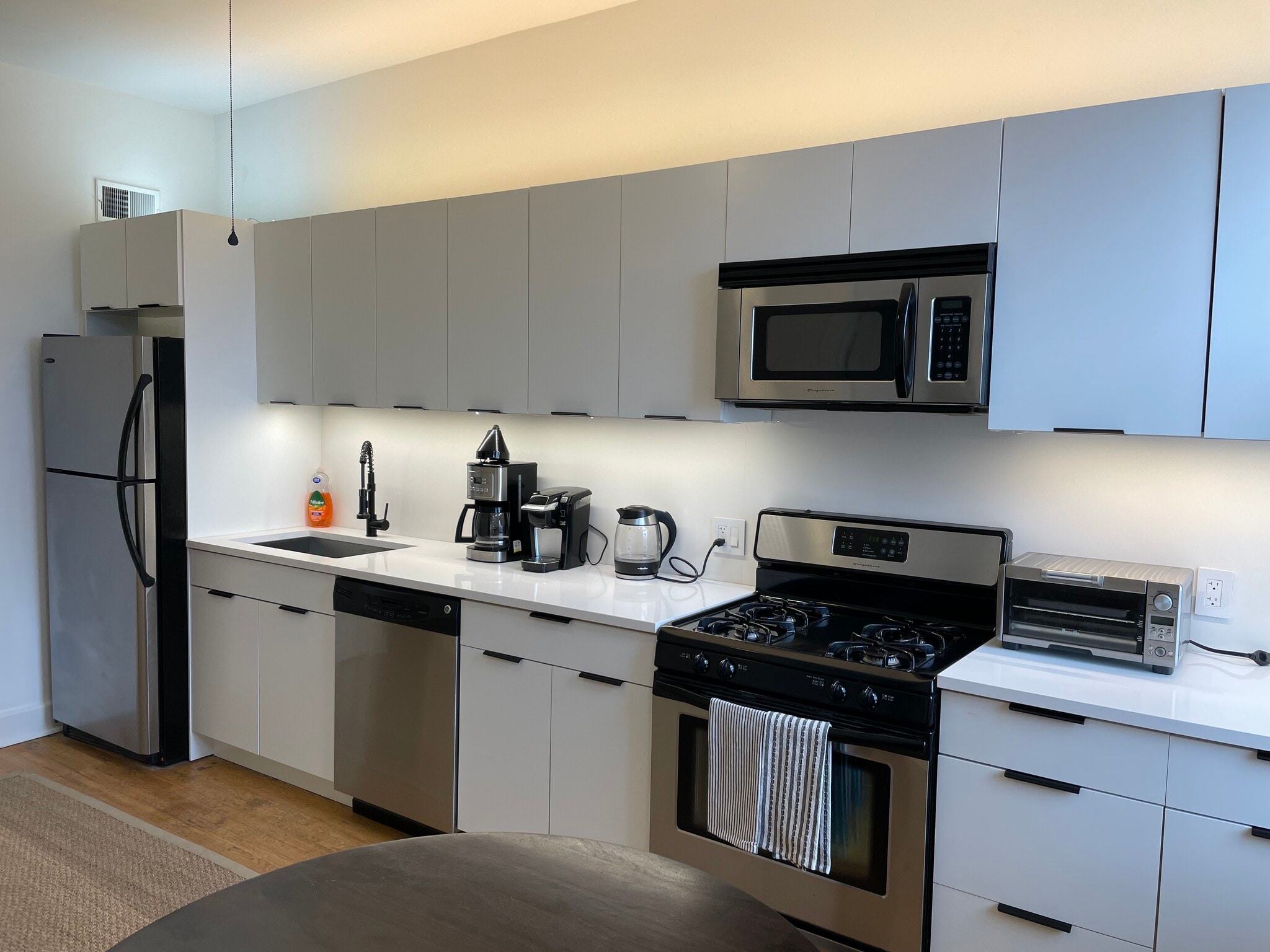 Fully furnished kitchen with coffee maker, hot water, pots, pans, plates, and silverware - 3489 N Elston Ave