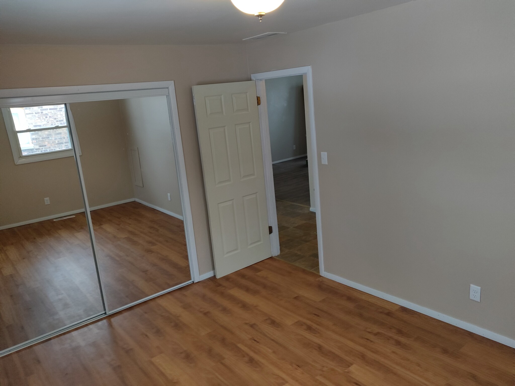 Bedrooms feature all new laminate flooring and mirrored closet doors. - 3348 brown st