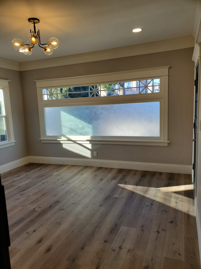 Livingroom with plenty of natural light and privacy. Original molding throughout living room. High end light fixture - 579 W. 13th St