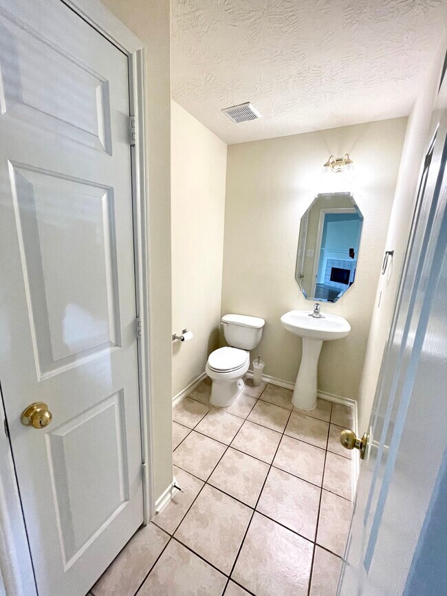 Service bathroom including an convenient attached storage. - 18911 Piney Bend Ct
