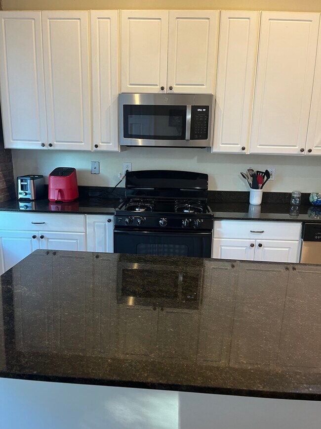 Kitchen with full stove; microwave, dishwasher, air fryer, and Keurig - 2219 Missouri Ave