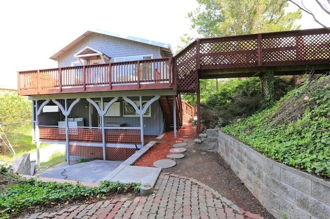View of the side of the house, the lower deck and patio - 3755 Faye dr