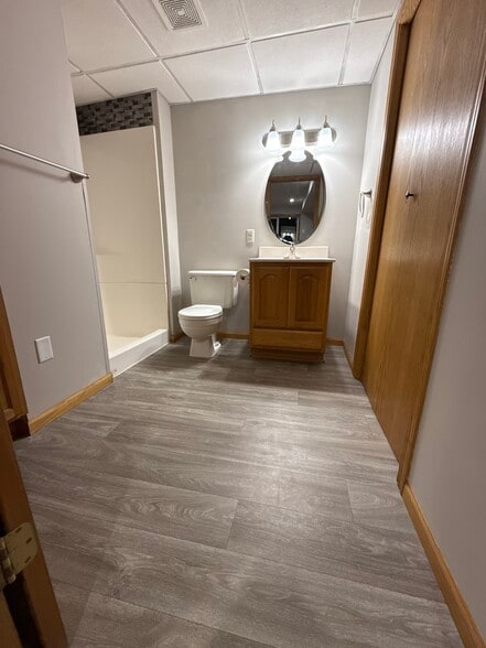 Updated lower-level bathroom with new flooring and modern fixtures. - 9092 Goldenrod Ln N