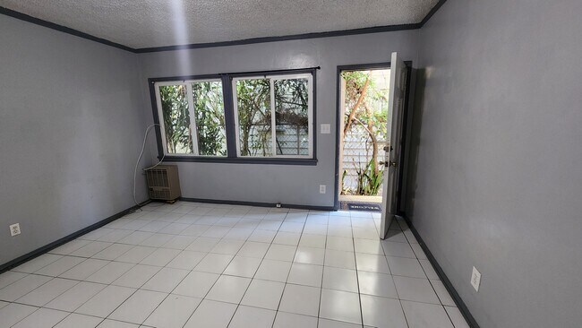 A tucked away studio in a residential neighborhood with a courtyard, backyard & covered carport. - 116 S Dillon St