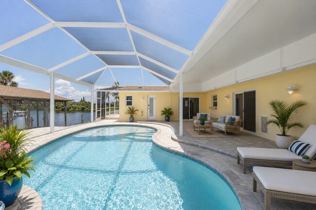 Building Photo - Live the ultimate Space Coast waterfront lifestyle at this stunning beachside canal home in Satel...