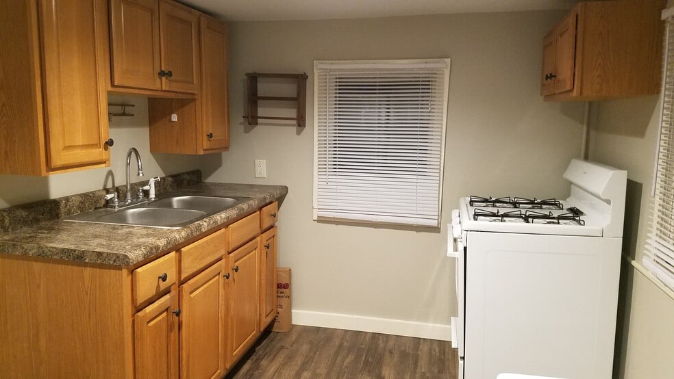 Kitchen includes stove and refrigerator - 103 12th W St