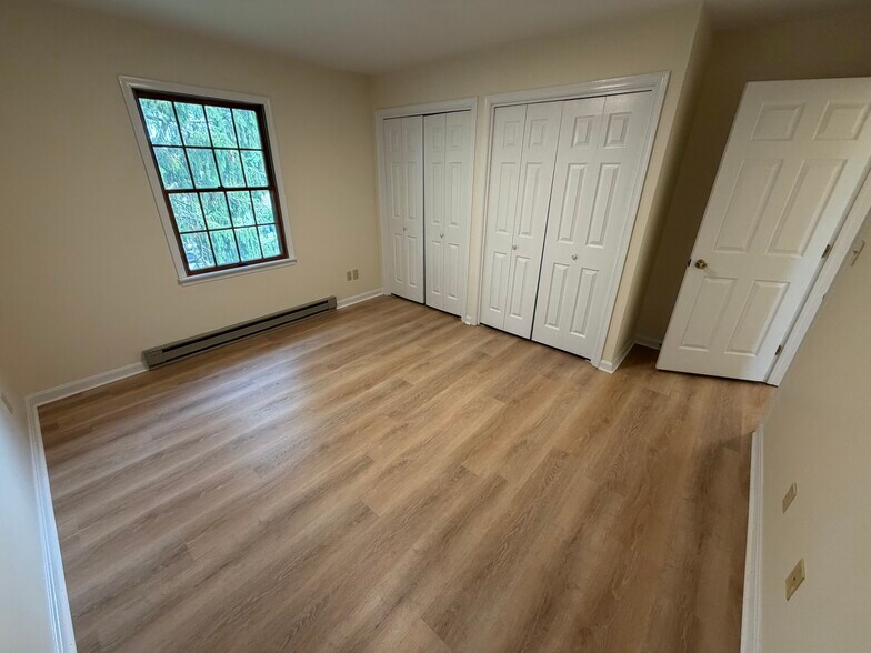 Stylish primary bedroom features dual closets - 917 Rose Hill Ave