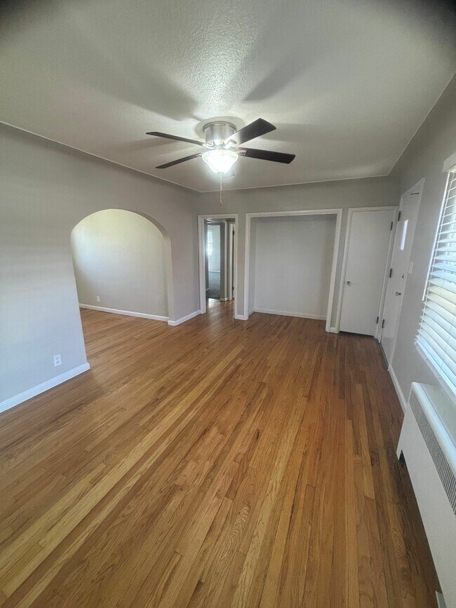 Experience the warmth of this inviting living area, enhanced by elegant hardwood floors and modern lighting. - Cottages on Vance