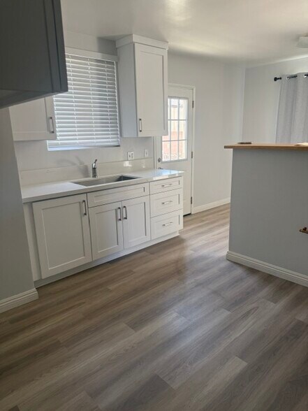 kitchen with new cabinets, new laminate flooring - 14523 Osage Ave