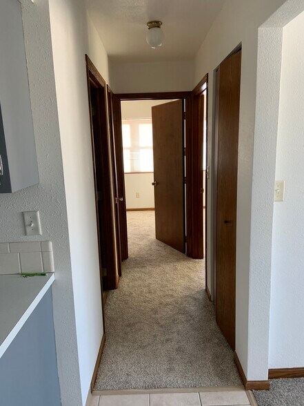 Hallway and 2 closets coming from kitchen going to bathroom and bedrooms. New carpeting and freshly painted walls. - 20427 W Clark Ave