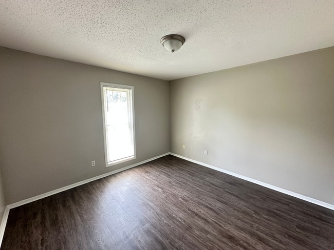 Building Photo - Charming 3BR/2BA Near Southwind | Soaring Vaulted Ceilings, Rustic Fireplace & Garage