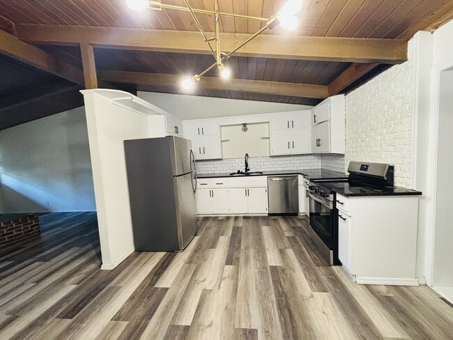 Building Photo - Quirky Mid-Century 3BR with High Beam Ceilings + Fenced Yard – $1,550