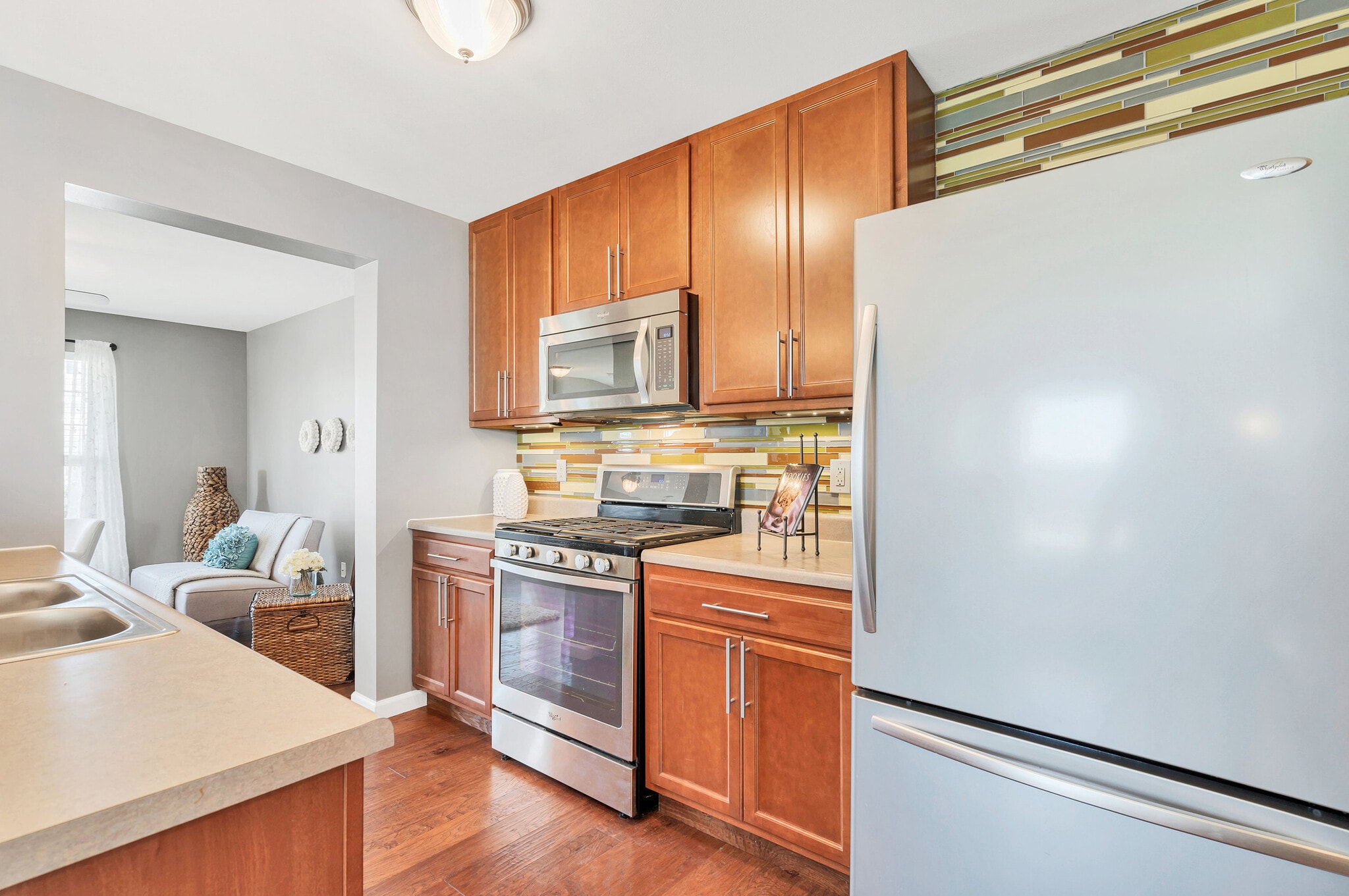 Designer kitchen with stainless appliances, glass backsplash and modern light fixtures - 201 Countryshire Dr