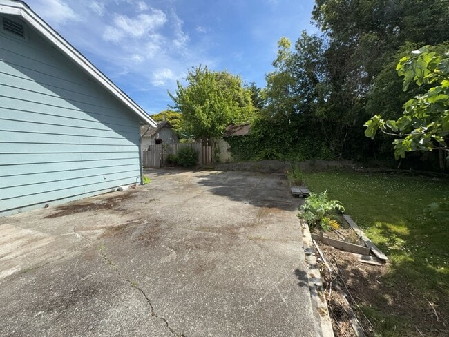 Building Photo - Sit out with your pet on the patio of this...