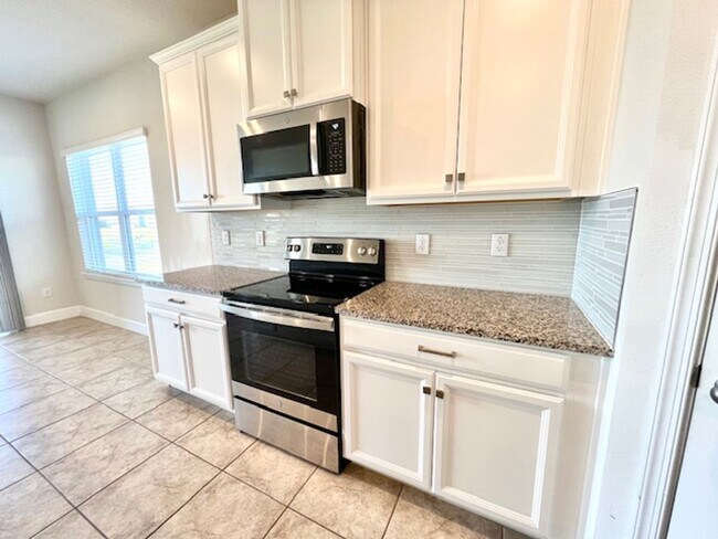 Building Photo - Open concept home offering four bedrooms, three baths, a two car garage and open lanai.