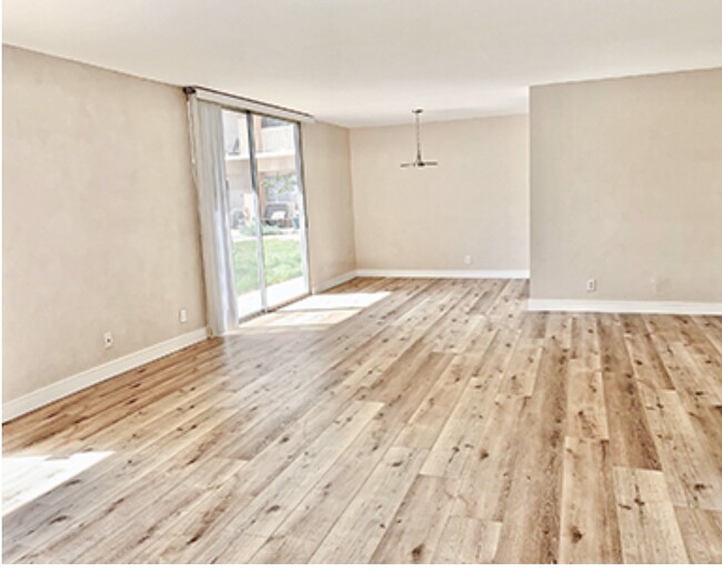 Living room showing Dining area - 100 S Doheny Dr