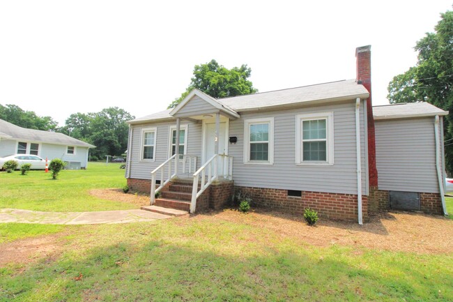 Building Photo - Charming home with updated Kitchen