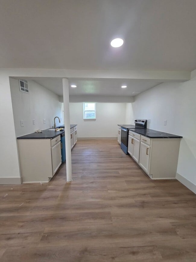 Building Photo - Studio Apartment with bathroom, kitchen & utility area on the lower level of property.