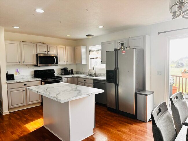 A freshly renovated kitchen featuring brand-new countertops and a fresh coat of paint - 4555 Cider Wood Dr NW