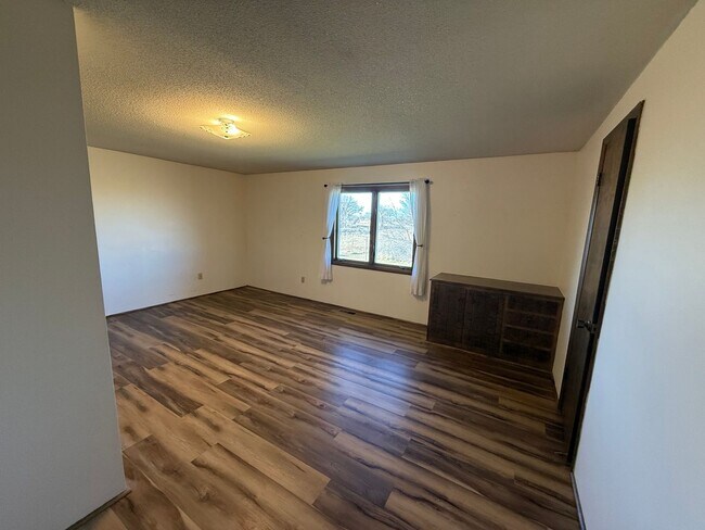 Building Photo - Spacious, four-bedroom, two-bathroom, coun...