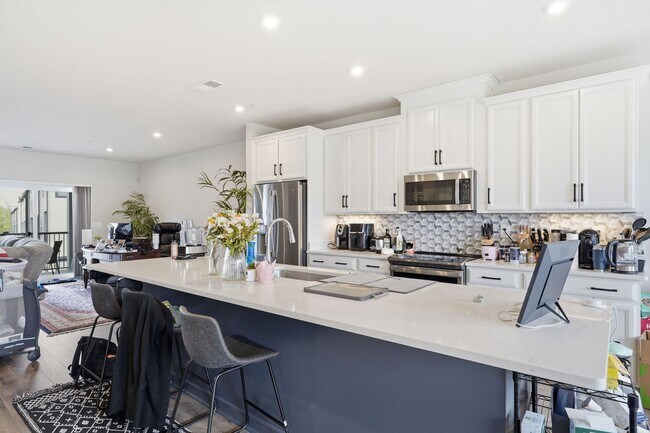 Building Photo - Perfectly positioned near the vibrant shopping and dining destination of One Loudoun, this reside...