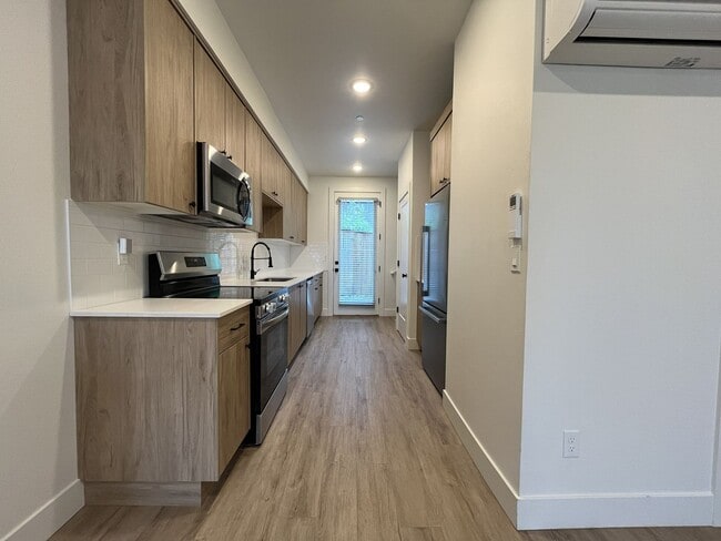 Building Photo - Modern 2-Bed, 1.5-Bath Condo with Custom Kitchen, Private Patio, and Prime Location