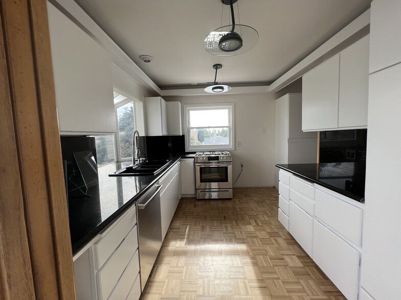 Kitchen with new stainless steel appliances - 831 W 3rd St