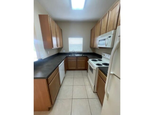 Building Photo - Spacious Gated Townhouse with Garage, Community Pool, and More!