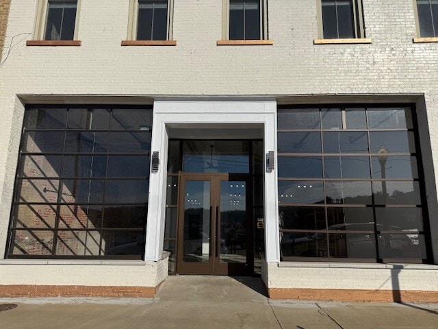 Commercial Space Front Door with Roll Up Doors Each Side - 206 E Main St