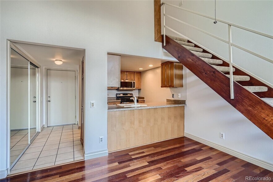 Entrance hallway, closet, open kitchen and stairs to loft - 14282 E Tufts Pl