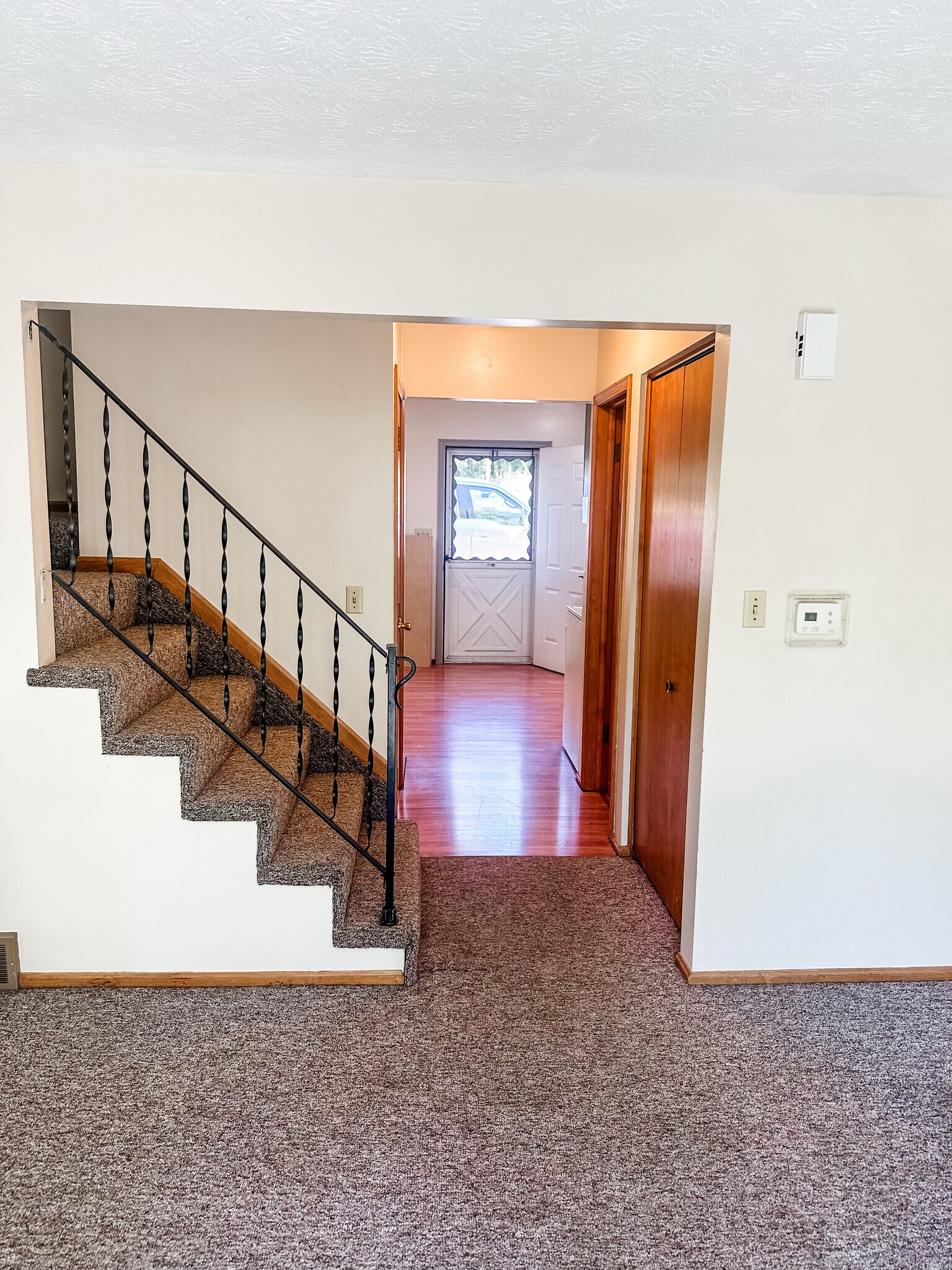 Hallway between kitchen and living space- with coat closet and half bath - 5229 Rule Rd