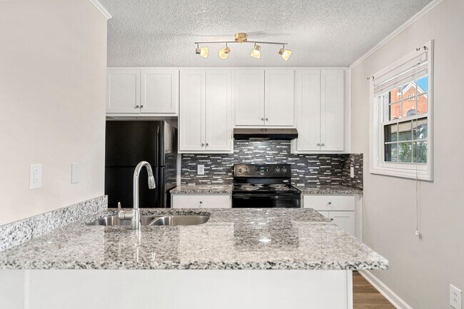 Building Photo - Introducing a Charming End Unit Townhouse ...