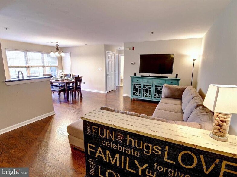Spacious living and dining area with lots of light and beautiful floors! - 501 Constellation Square SE