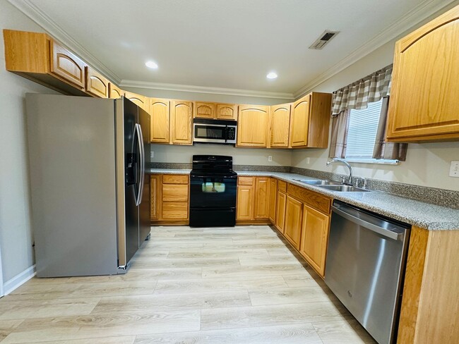 Building Photo - 2 bed, 2.5 bath updated townhouse w/ 1-car garage & Trex deck available now