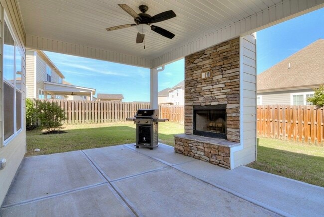 Covered patio with wood fireplace - 5464 Everlook Cir