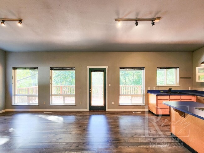 Building Photo - Vaulted Ceilings, Unique Designer Kitchen & Expansive Half-Acre Setting with Flexible Living Spaces