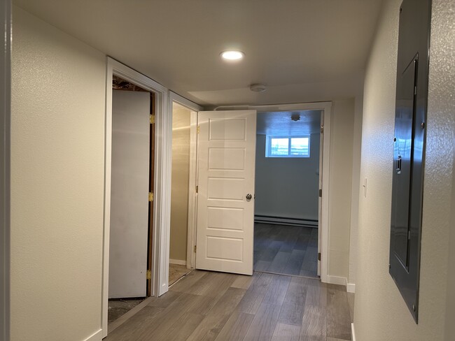 Hallway with storage closet, utility closet and 3 bedrooms - 1137 E Platte Ave