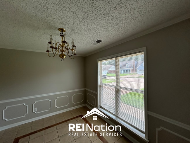 Building Photo - Spacious 4BR/2BA Near Southwind | High Ceilings, Brick Fireplace & 2-Car Garage