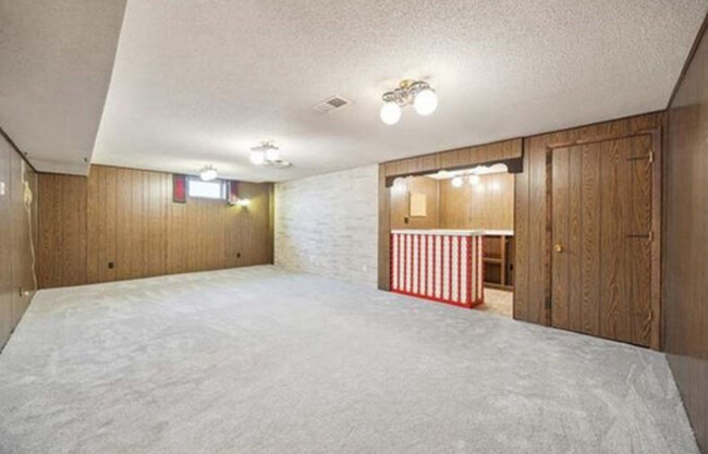 Downstairs entertainment area complete with bar and fridge. - 5709 Goodrich Ave