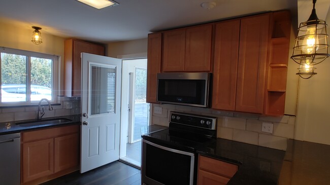 Kitchen opens out to sun room and exit to garage - 6934 Winding Way