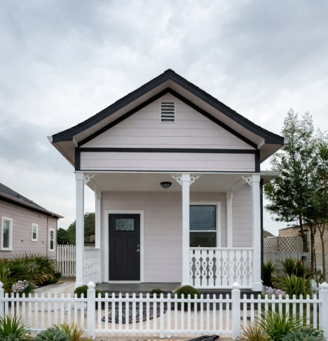 Detached home with a private covered porch, seating area, and charming architectural details. - 262 Soledad St