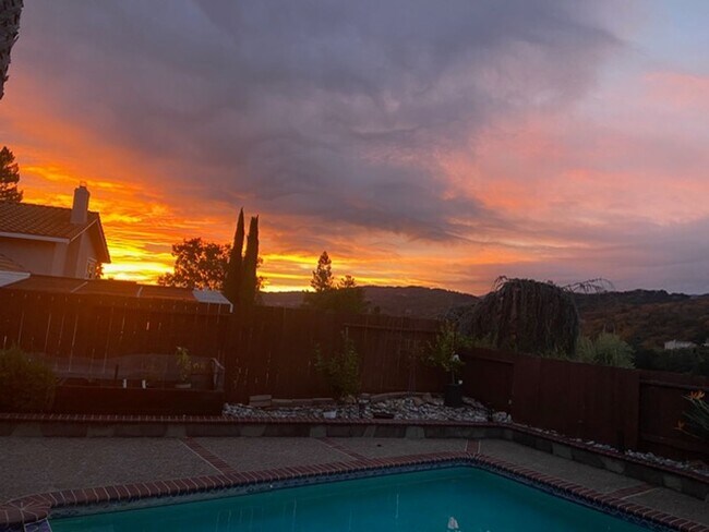 Building Photo - Remodeled 5 Bedroom Home with Heated Pool, Hillside Views, Solar, and Sunrise and Sunset Views in...