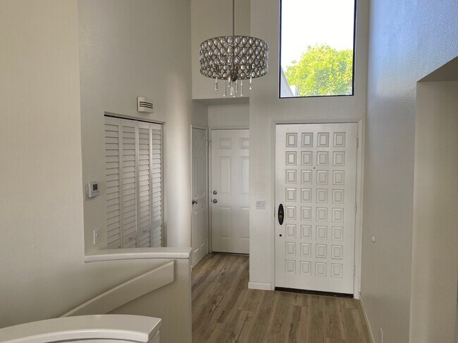 Entry closet, guest bathrm, garage door - 811 Spindrift Dr
